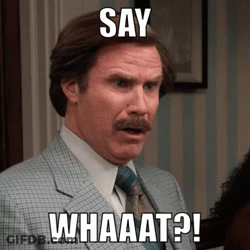 A Man In A Suit And Tie With The Words Say Whaaat On His Face GIF