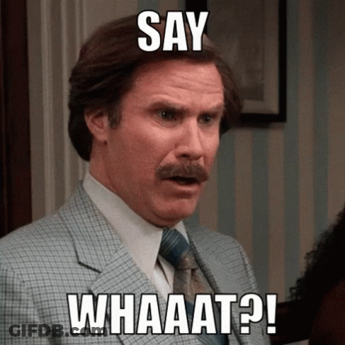 A Man In A Suit And Tie With The Words Say Whaaat On His Face GIF