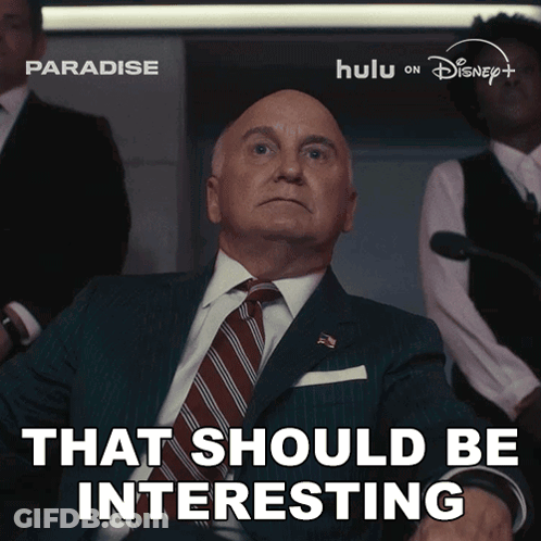 A Man In A Suit And Tie With The Words That Should Be Interesting Below Him GIF