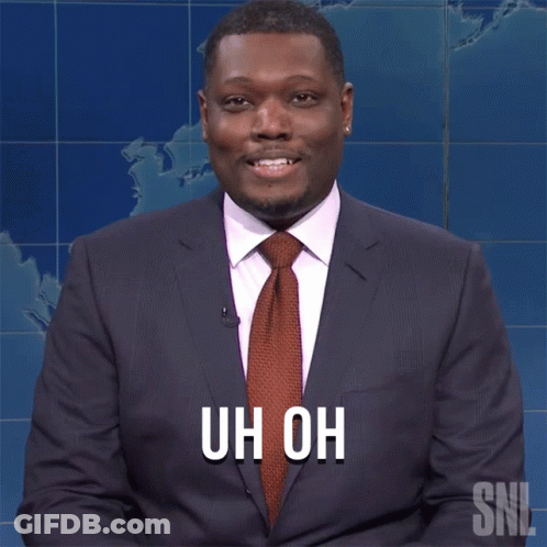 A Man In A Suit And Tie With The Words Uh Oh On His Chest GIF