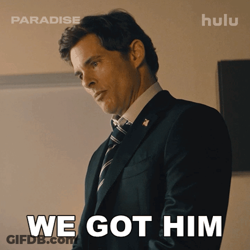 A Man In A Suit And Tie With The Words We Got Him Behind Him GIF