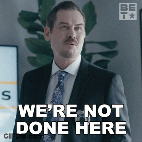 A Man In A Suit And Tie With The Words We 'Re Not Done Here GIF