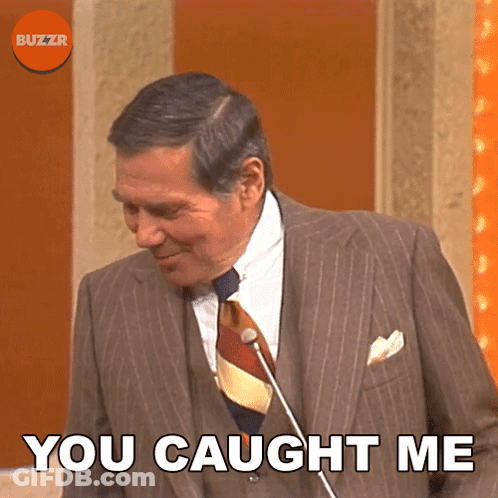 A Man In A Suit And Tie With The Words You Caught Me Below Him GIF