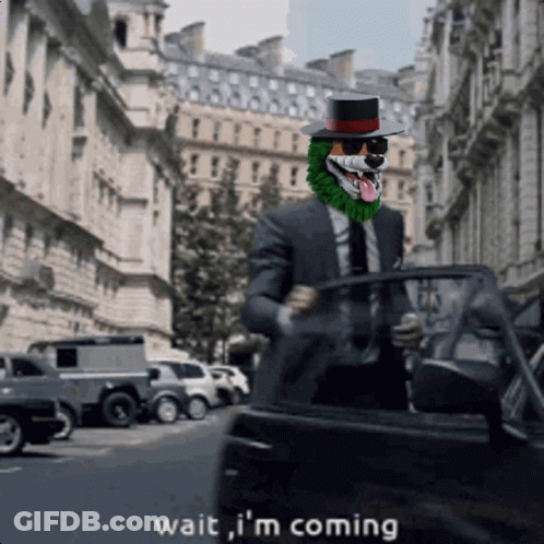 A Man In A Suit And Top Hat Says Wait I 'M Coming As He Gets Out Of A Car GIF