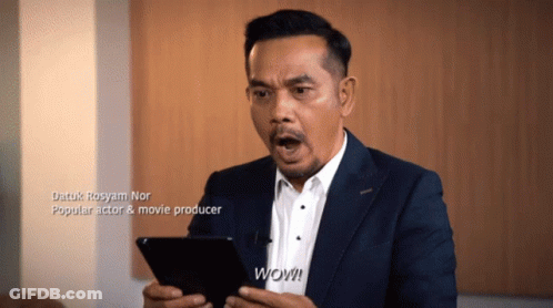 A Man In A Suit And White Shirt Holds A Tablet And Says Wow GIF