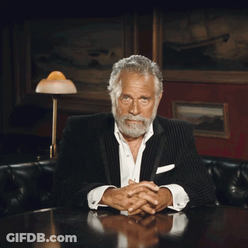 A Man In A Suit And White Shirt Is Laughing GIF