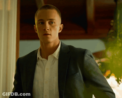 A Man In A Suit And White Shirt Is Looking At The Camera GIF