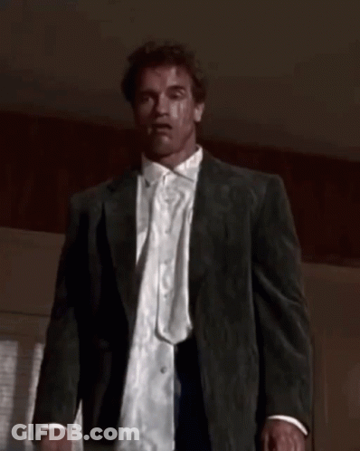 A Man In A Suit And White Shirt Is Looking At The Camera GIF