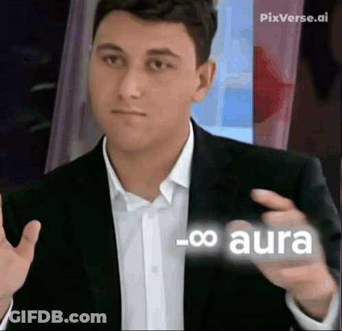 A Man In A Suit And White Shirt Is Pointing At Something With The Word Aura On It GIF