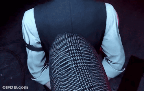 A Man In A Suit And White Shirt Is Sitting On A Woman 'S Lap GIF