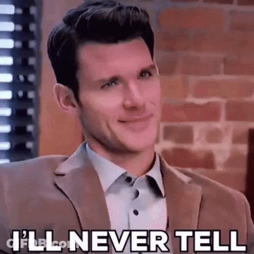 A Man In A Suit And White Shirt Is Smiling And Saying `` I 'Ll Never Tell '' . GIF