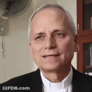 A Man In A Suit And White Shirt Is Smiling GIF