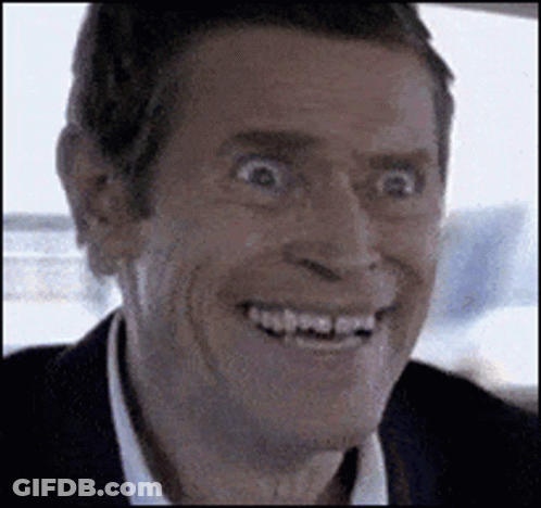 A Man In A Suit And White Shirt Is Smiling With His Mouth Open . GIF