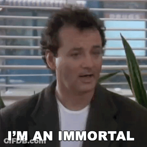 A Man In A Suit And White Shirt Is Standing In Front Of A Window And Says `` I 'M An Immortal '' . GIF