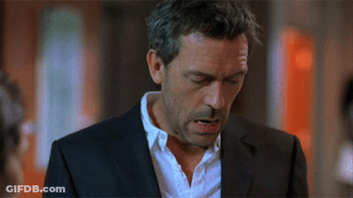 A Man In A Suit And White Shirt Looks Down With His Eyes Closed GIF