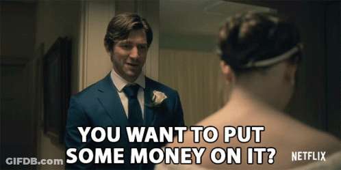 A Man In A Suit Asks A Woman If She Wants To Put Some Money On Her GIF