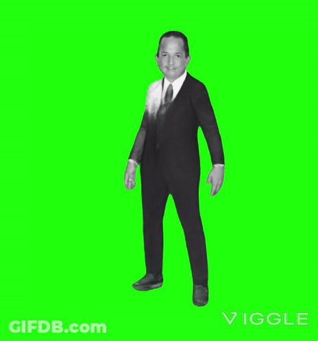 A Man In A Suit Dancing On A Green Screen GIF
