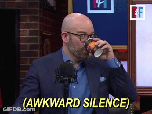 A Man In A Suit Drinking From A Cup With The Words Awkward Silence Below Him GIF