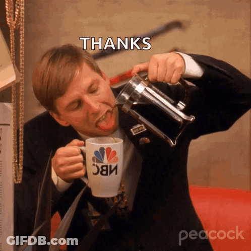 A Man In A Suit Drinking From A Nbc Mug GIF