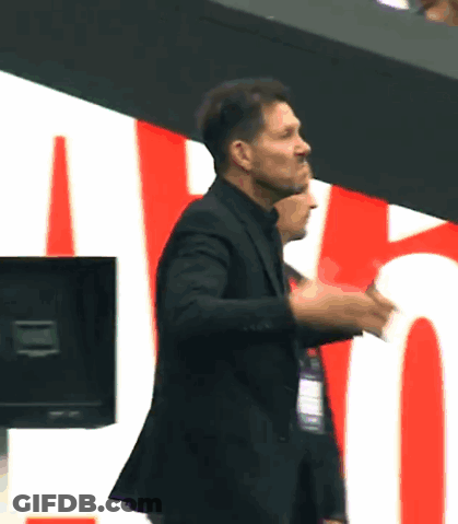 A Man In A Suit Giving A Thumbs Up Sign GIF