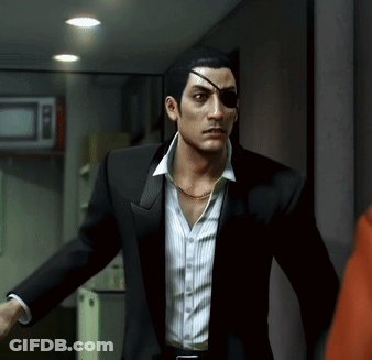 A Man In A Suit Has A Bandage On His Eye GIF