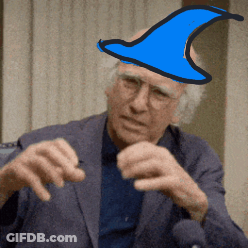 A Man In A Suit Has A Blue Hat On Top Of His Head GIF