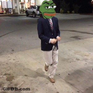A Man In A Suit Has A Green Frog Head On His Head GIF