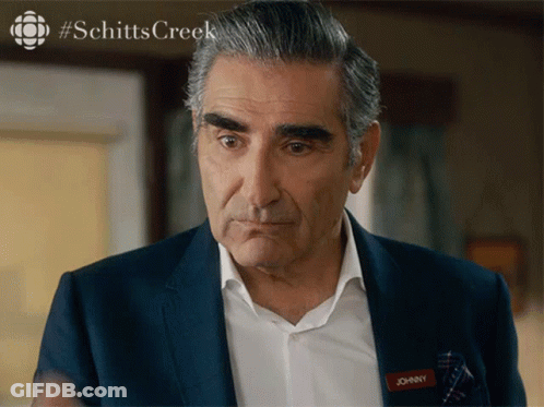 A Man In A Suit Has A Name Tag That Says Johnny On It GIF