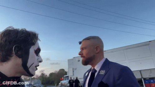 A Man In A Suit Has A Pin On His Lapel That Says Cbs GIF