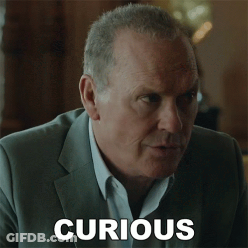 A Man In A Suit Has The Word Curious Written On The Bottom Of His Face GIF