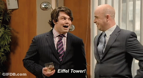 A Man In A Suit Holds A Glass Of Whiskey And Says " Eiffel Tower " GIF