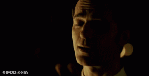 A Man In A Suit Holds Another Man 'S Head GIF