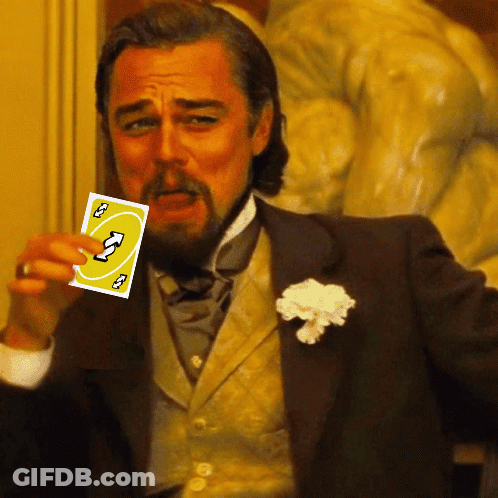 A Man In A Suit Holds Up A Card That Says ' U ' On It GIF