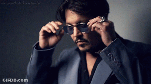 A Man In A Suit Is Adjusting His Sunglasses With The Words Theroseinthedarkness Tumblr In The Corner GIF