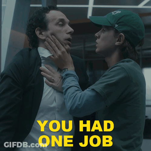 A Man In A Suit Is Being Held By A Woman In A Green Hat With The Words " You Had One Job " In Yellow GIF