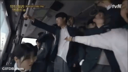 A Man In A Suit Is Being Held Up By A Group Of People In A Bus . GIF