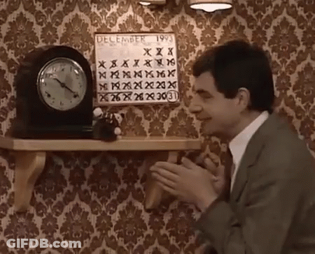 A Man In A Suit Is Clapping In Front Of A Calendar That Says December 1993 GIF