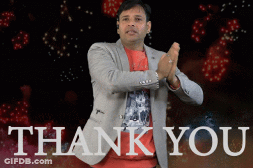 A Man In A Suit Is Clapping In Front Of A Thank You Sign GIF