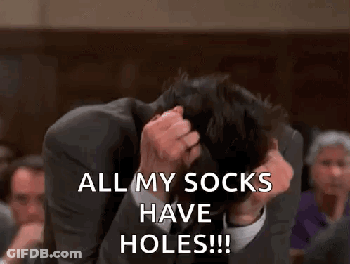 A Man In A Suit Is Covering His Face With His Hands And Saying `` All My Socks Have Holes ! '' GIF