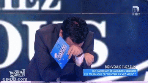 A Man In A Suit Is Crying While Holding A Book That Says Touche Pas Mon Poste GIF