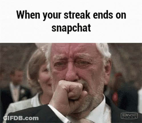 A Man In A Suit Is Crying While Holding His Fist To His Mouth . GIF