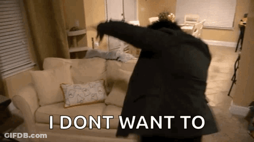 A Man In A Suit Is Dancing In A Living Room With The Words I Dont Want To Written On The Floor GIF