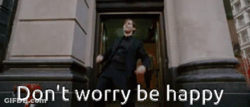 A Man In A Suit Is Dancing In Front Of A Building With The Words " Do N't Worry Be Happy " Written Below Him GIF
