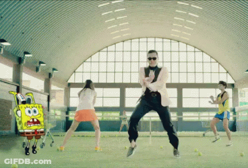A Man In A Suit Is Dancing In Front Of A Spongebob Cartoon GIF