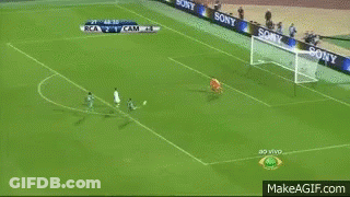 A Man In A Suit Is Dancing On A Soccer Field . GIF