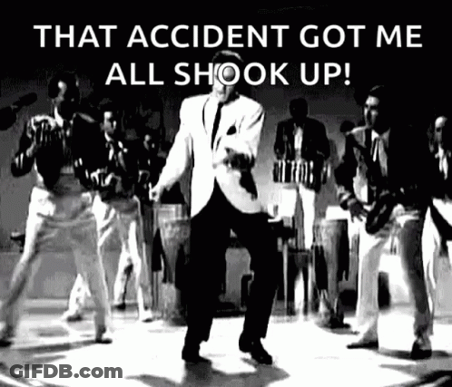 A Man In A Suit Is Dancing On A Stage In Front Of A Group Of Men . GIF