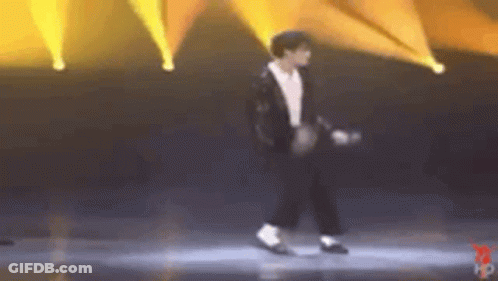Man In Suit Dancing Under Yellow Lights GIF