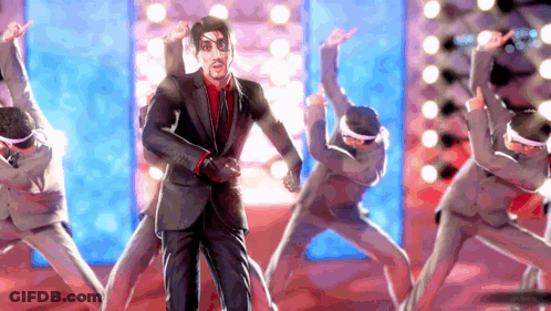 A Man In A Suit Is Dancing With A Group Of People GIF