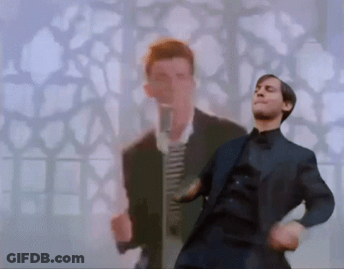 A Man In A Suit Is Dancing With Another Man In A Suit In The Background . GIF