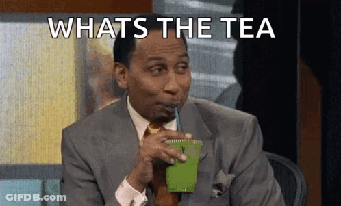 A Man In A Suit Is Drinking A Green Smoothie With A Straw . GIF